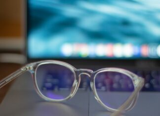 Blue-Light Glasses: What the Cochrane Review Found A pair of silver-framed eyeglasses resting on a white table