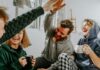 Two Researchers Disagreed About Money and Happiness. So They Ran the Study Together. Four friends laughing together over coffee