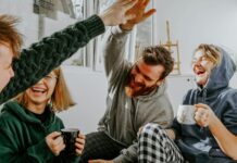 Two Researchers Disagreed About Money and Happiness. So They Ran the Study Together. Four friends laughing together over coffee