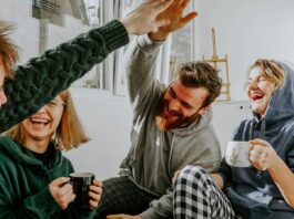 Two Researchers Disagreed About Money and Happiness. So They Ran the Study Together. Four friends laughing together over coffee