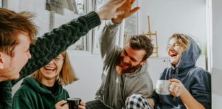 Two Researchers Disagreed About Money and Happiness. So They Ran the Study Together. Four friends laughing together over coffee