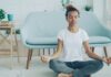 The Meditation Researchers Auditing Their Own Field A young woman sitting cross-legged meditating on the floor at home