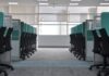 Empty office chairs at cubicles