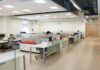 The Open Office Was Built on a Measurement. Then Nobody Measured It Again for Sixty Years. An open plan office with long rows of white desks