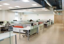 The Open Office Was Built on a Measurement. Then Nobody Measured It Again for Sixty Years. An open plan office with long rows of white desks