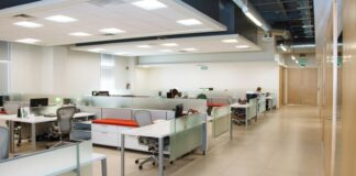 The Open Office Was Built on a Measurement. Then Nobody Measured It Again for Sixty Years. An open plan office with long rows of white desks