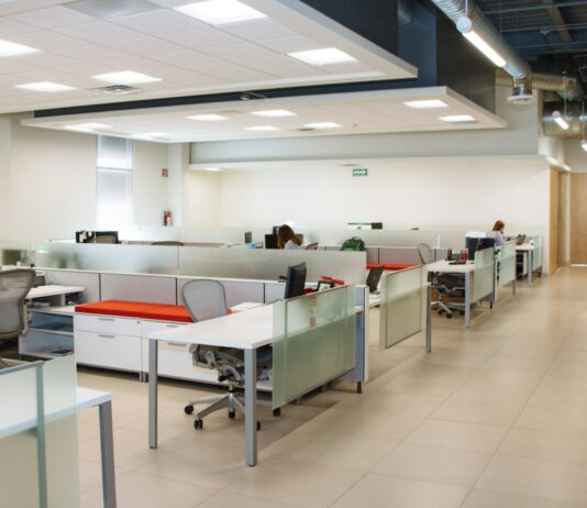 The Open Office Was Built on a Measurement. Then Nobody Measured It Again for Sixty Years. An open plan office with long rows of white desks