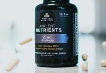 The Vitamin D Trials Nobody Talks About A bottle of vitamin supplements on a plain surface
