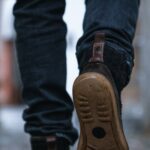 Close-up of a person walking on a pavement