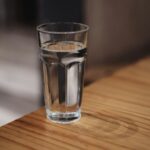 A glass of water on a wooden surface