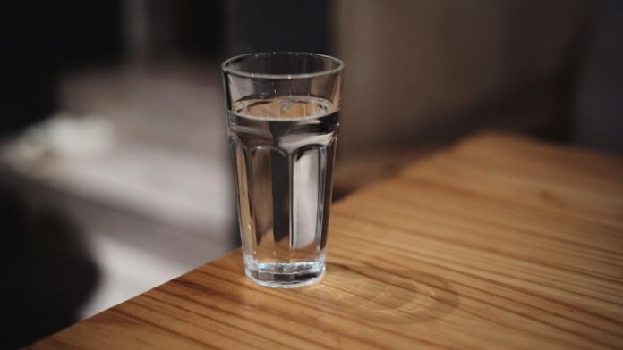 A glass of water on a wooden surface